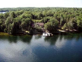 Aerial view of cottage on lake